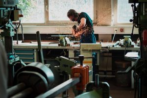 Man using grinding tool in a workshop
